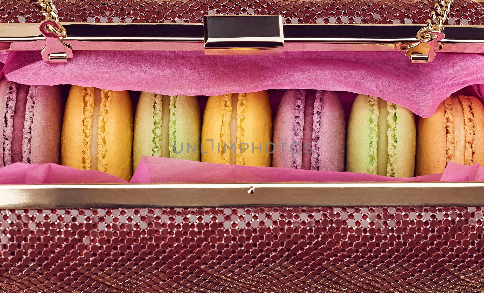 Macarons in shiny fashion handbag on gold.Vintage by 918