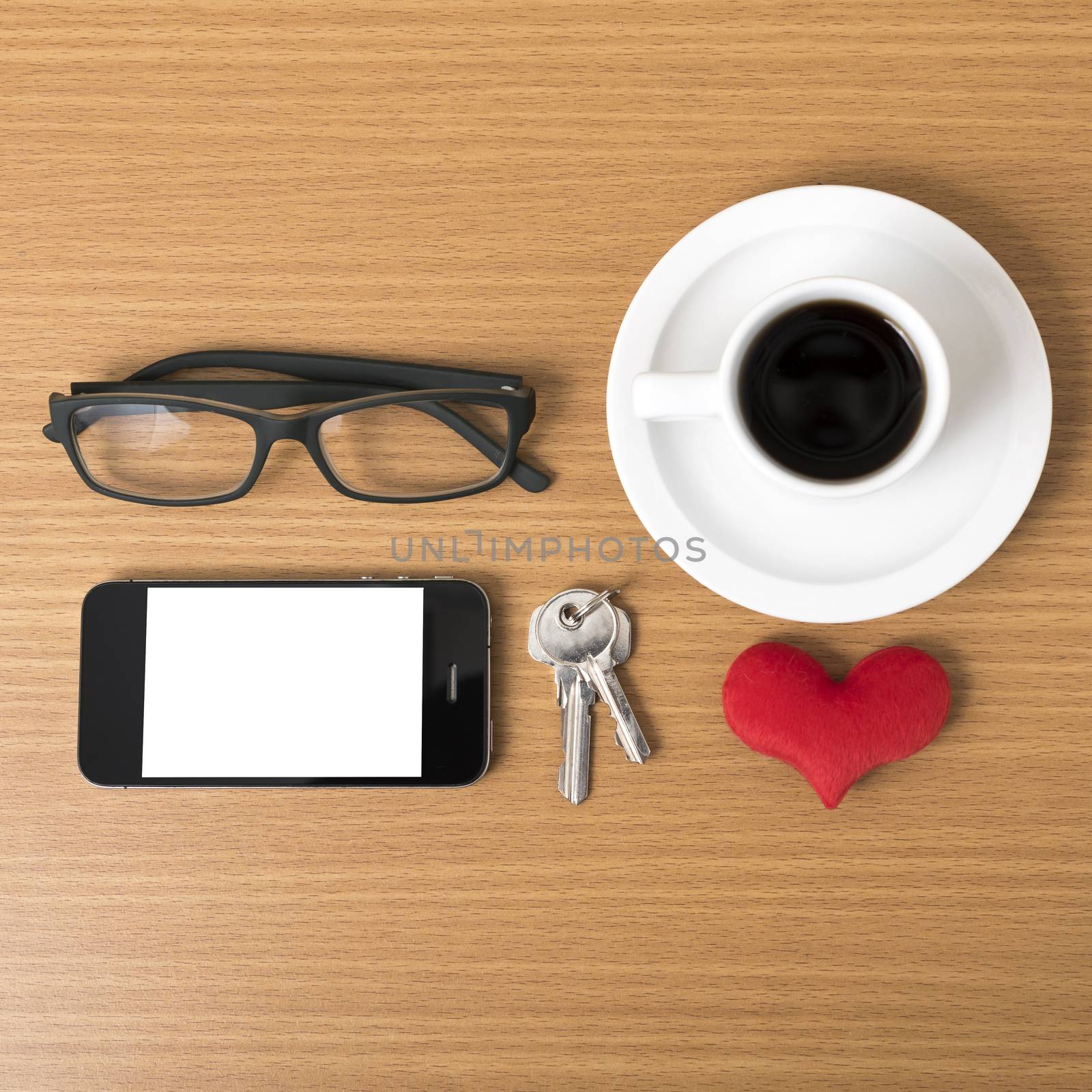 coffee,phone,eyeglasses,key and heart on wood table background