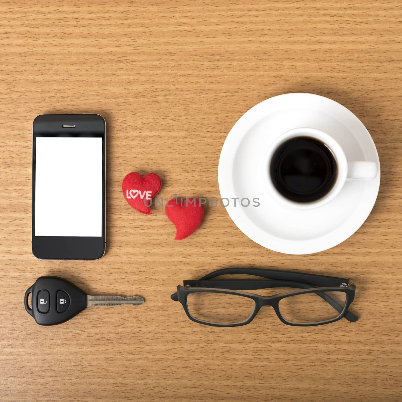 coffee,phone,eyeglasses,car key and heart on wood table background