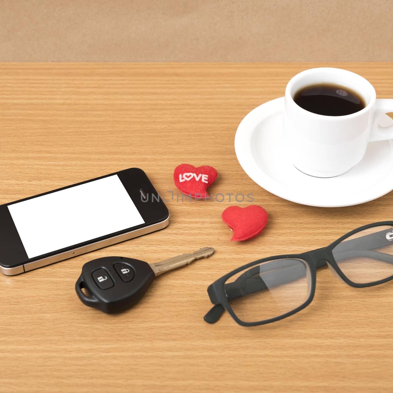 coffee,phone,eyeglasses,car key and heart on wood table background