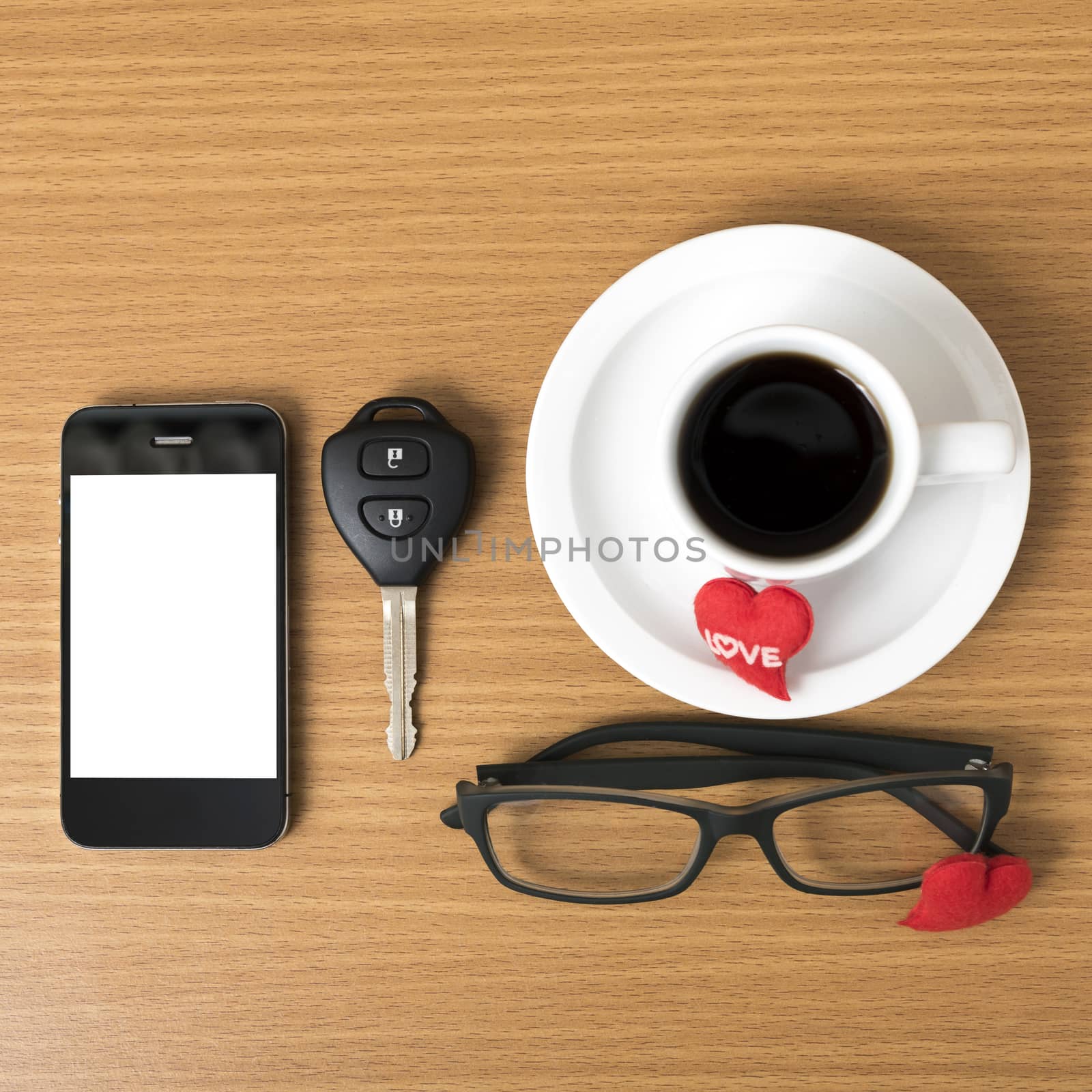 coffee,phone,eyeglasses,car key and heart on wood table background