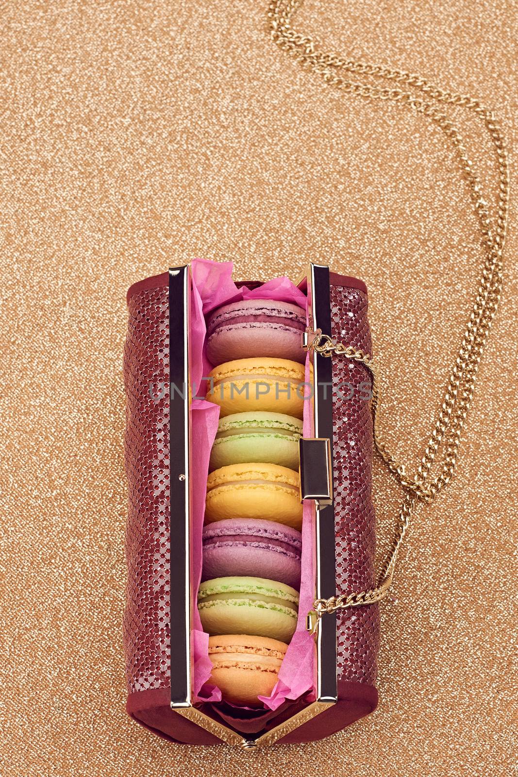 Macarons in shiny fashion handbag on gold.Vintage by 918