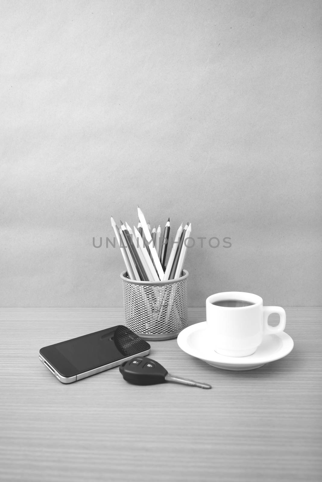 coffee,phone,car key and heart on wood table background black and white color