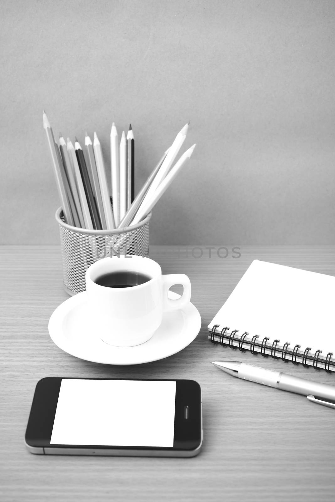 coffe,phone,notepad and color pencil on wood table background black  and white color