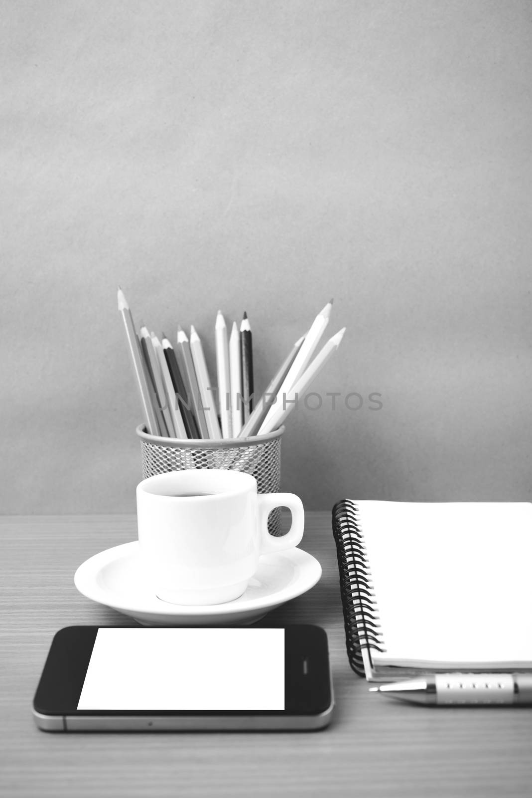 coffe,phone,notepad and color pencil on wood table background black  and white color