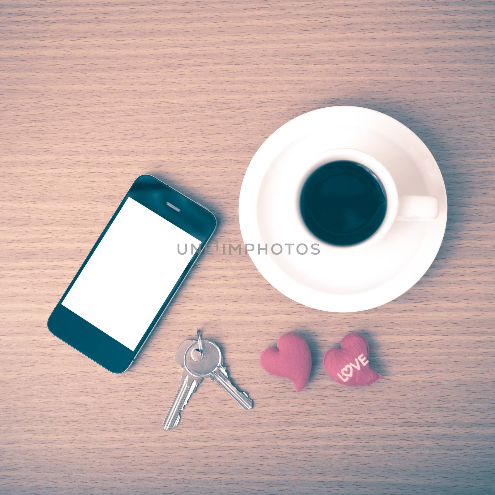 coffee phone key and heart on wood table background vintage style