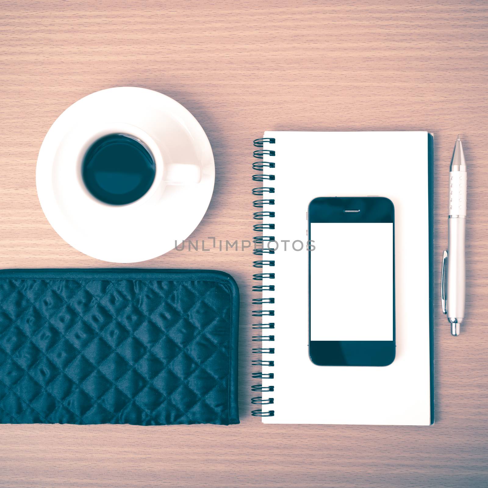coffee,phone,notepad and wallet on wood table background vintage style
