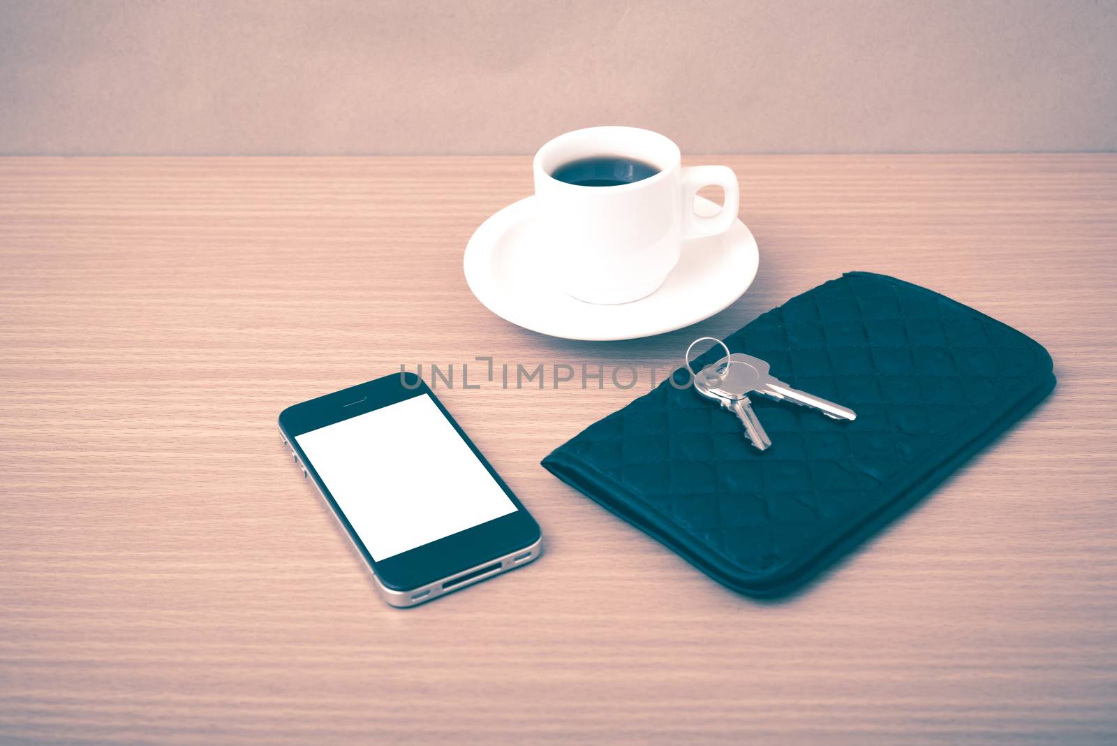 coffee phone key and wallet on wood table background vintage style