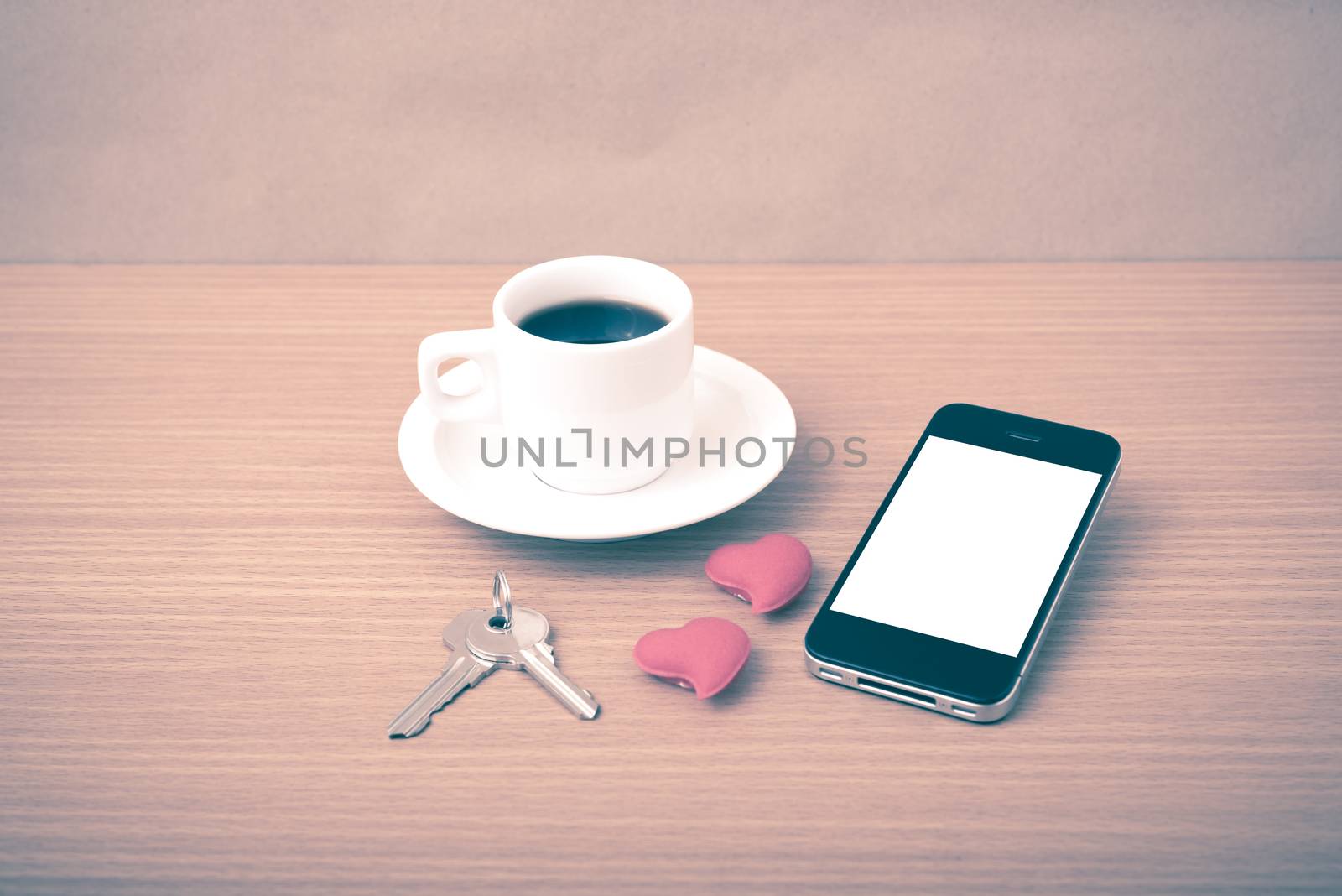 coffee phone key and heart on wood table background vintage style