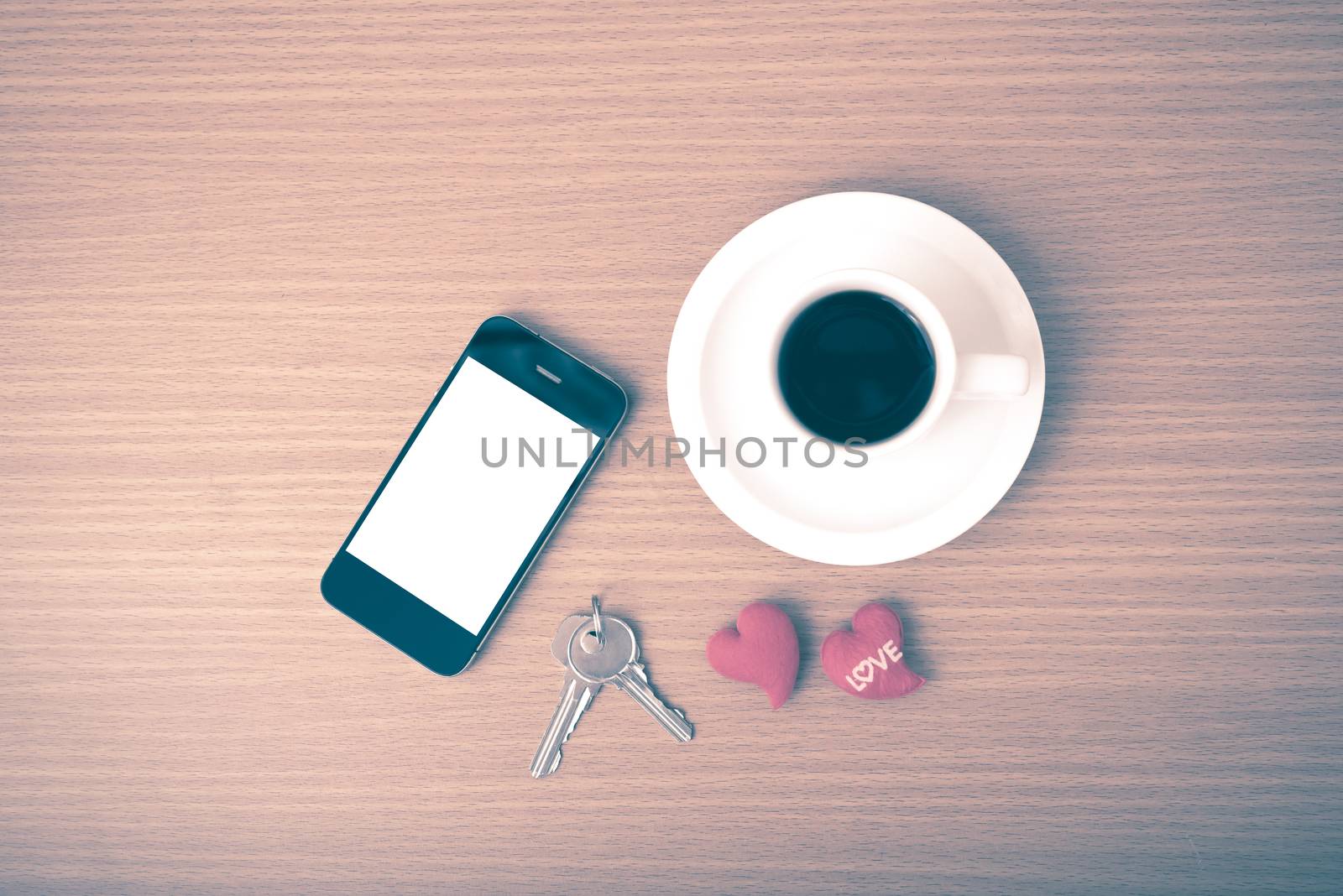 coffee phone key and heart on wood table background vintage style