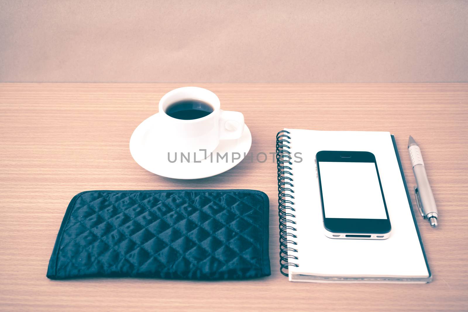 coffee,phone,notepad and wallet on wood table background vintage style