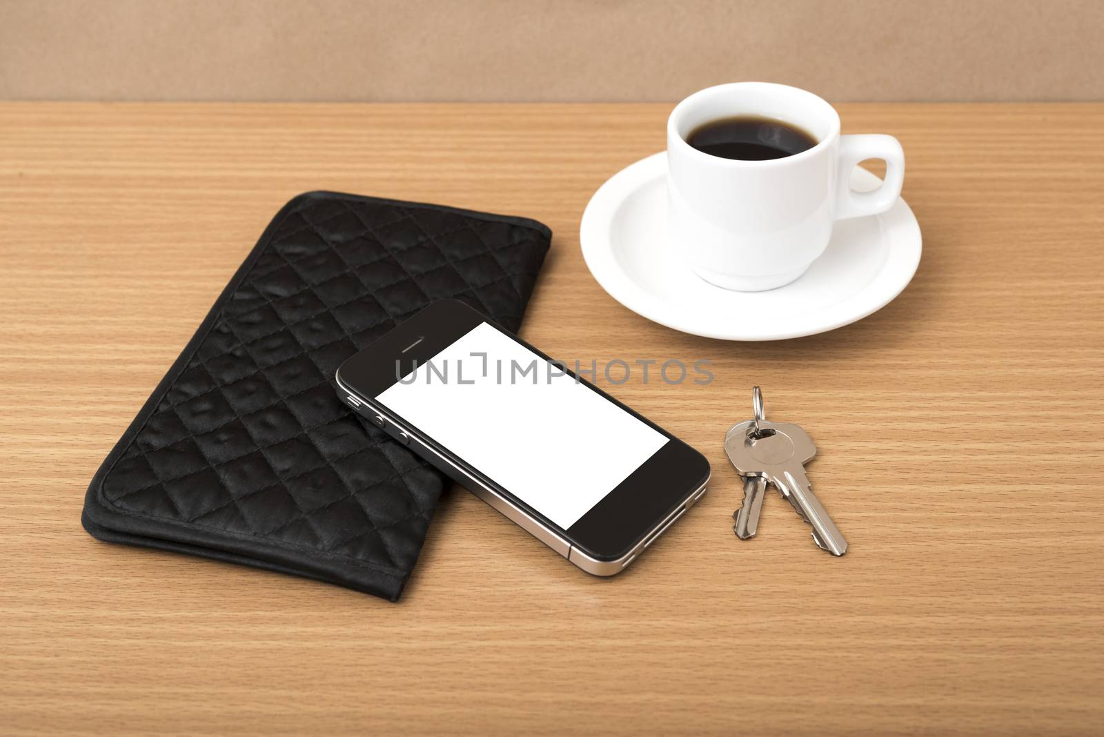 coffee phone key and wallet on wood table background