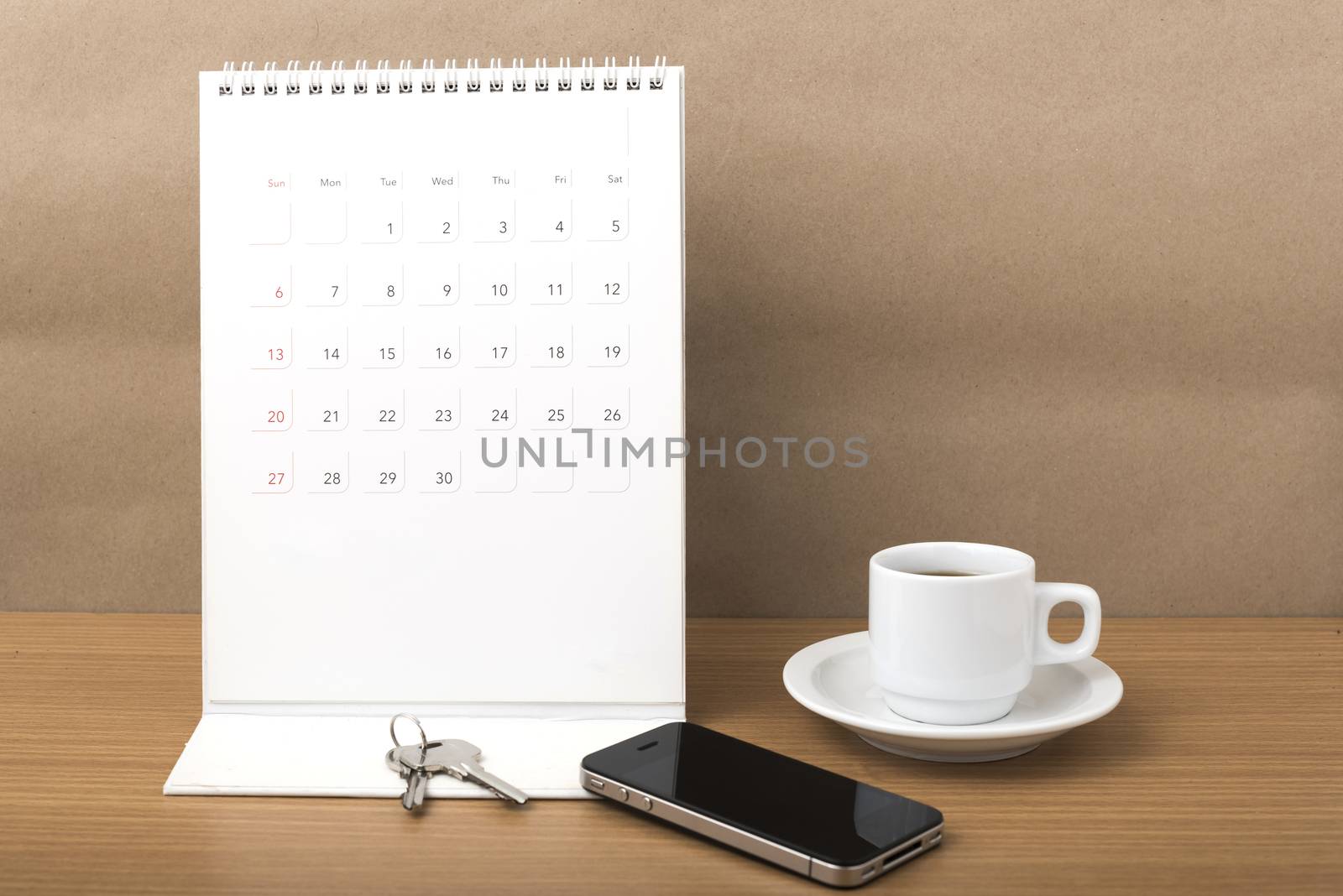 coffee,phone,key and calendar on wood table background