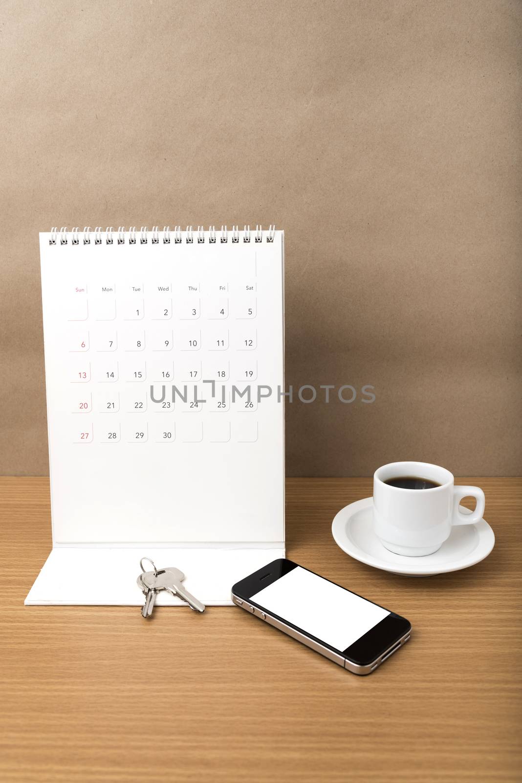 coffee,phone,key and calendar on wood table background