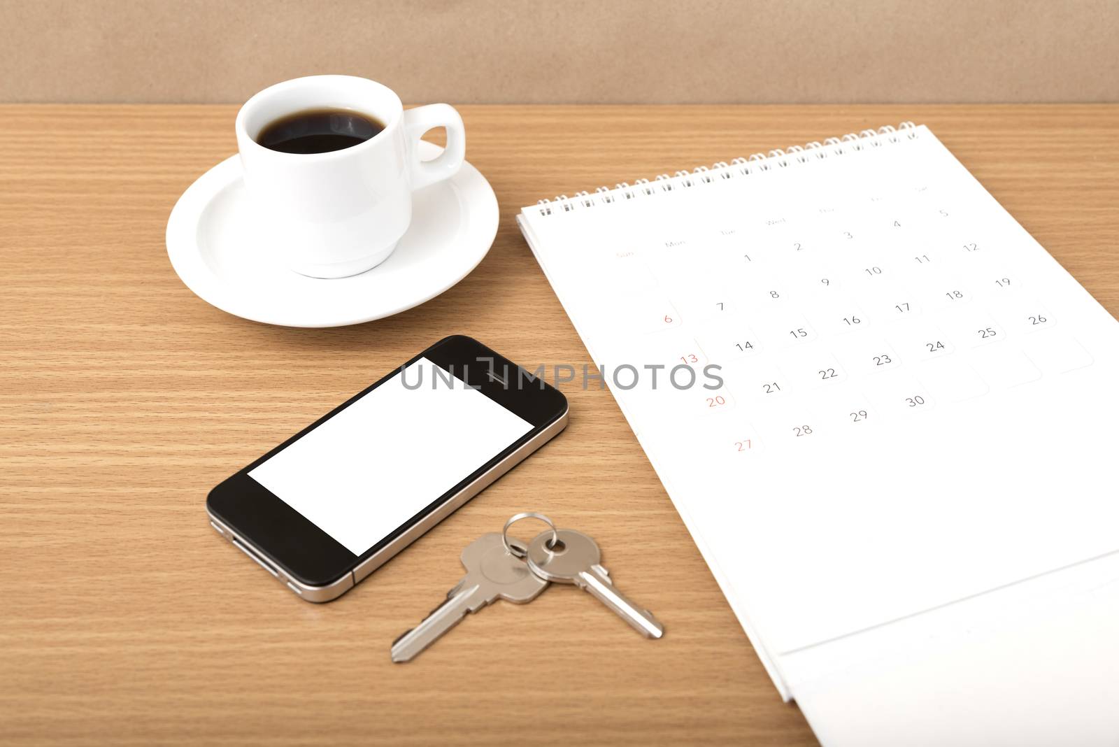 coffee,phone,key and calendar on wood table background