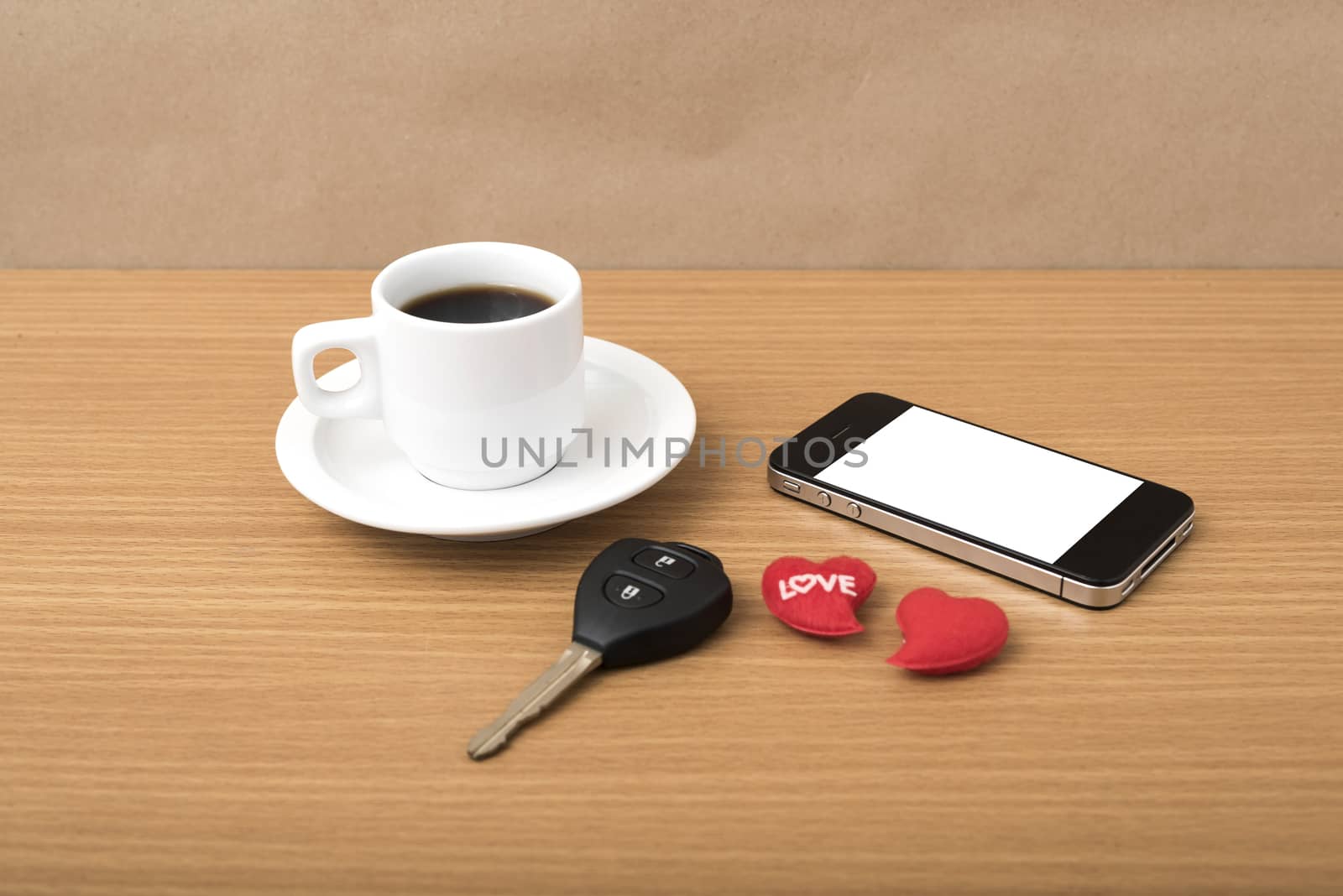 coffee phone car key and heart on wood table background