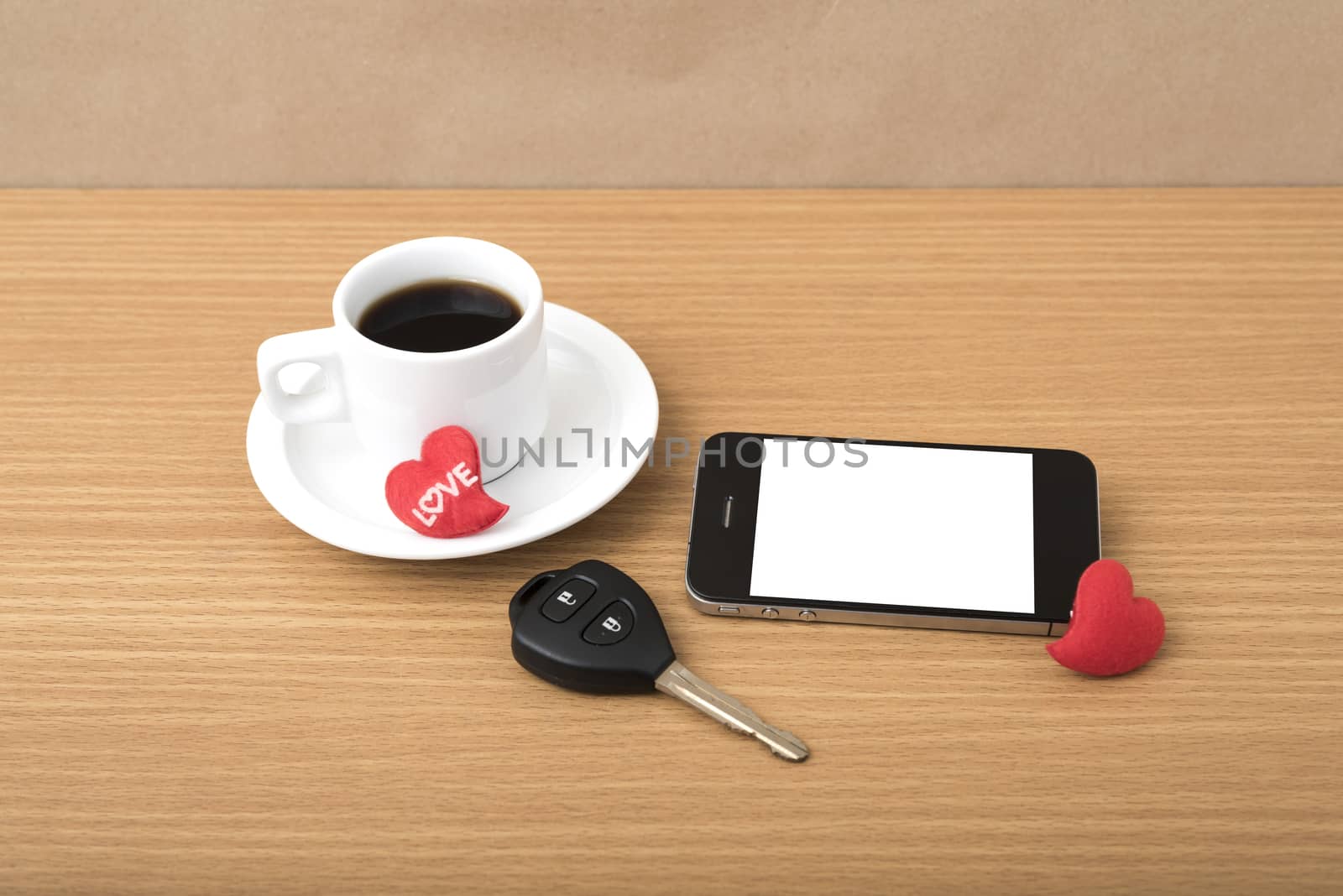 coffee phone car key and heart on wood table background