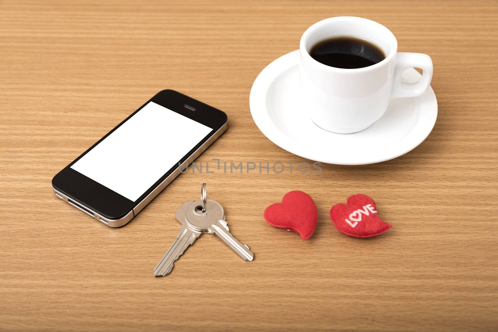 coffee phone key and heart on wood table background