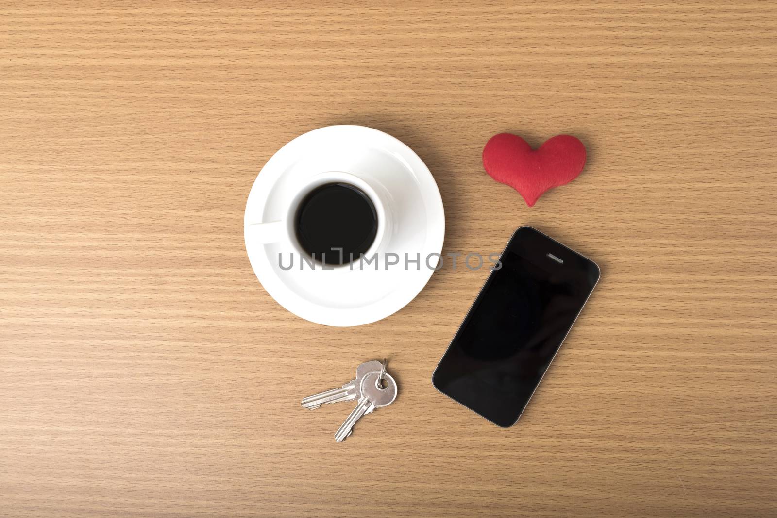 coffee phone key and heart on wood table background