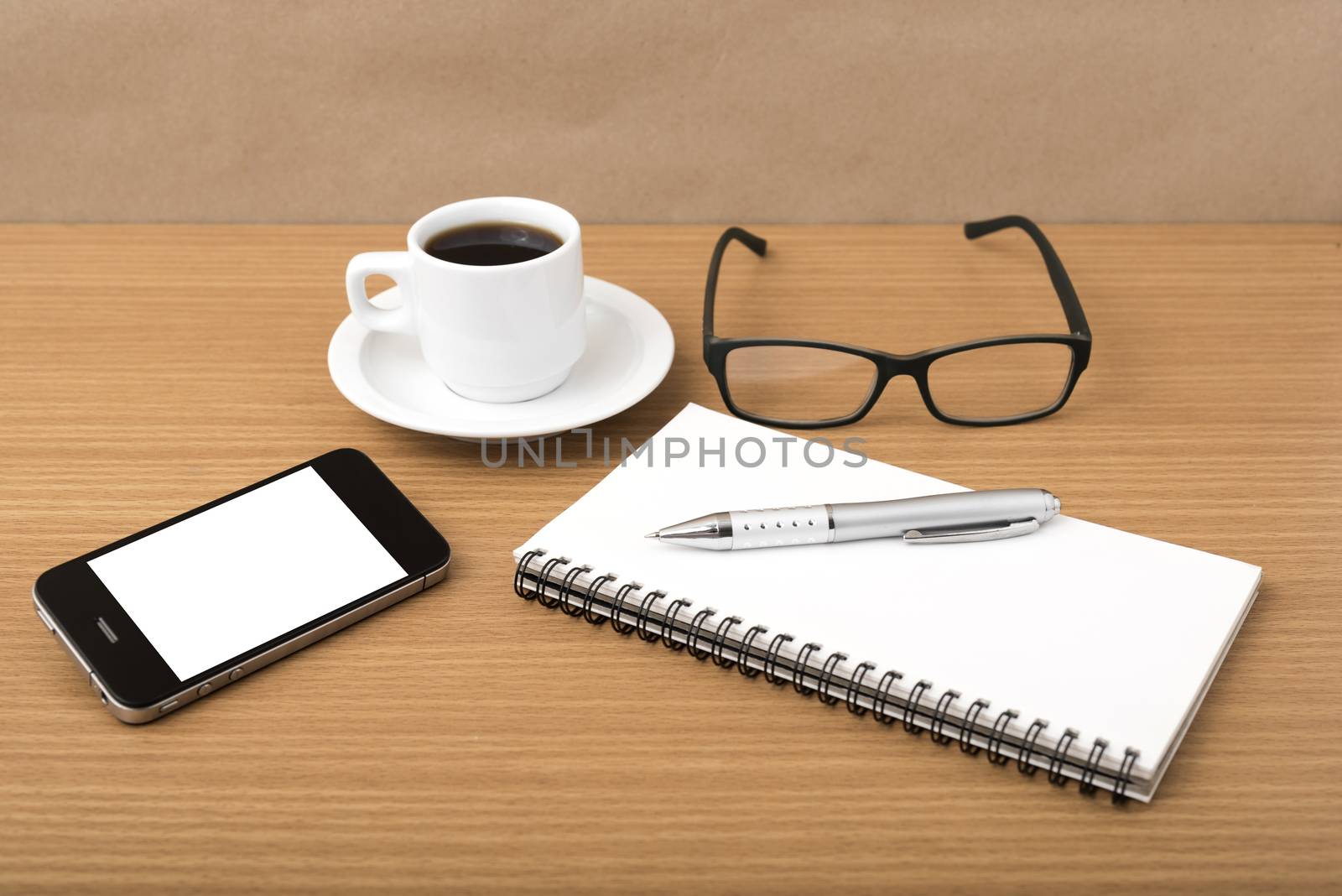coffee,phone,notepad and eyeglasses on wood table background