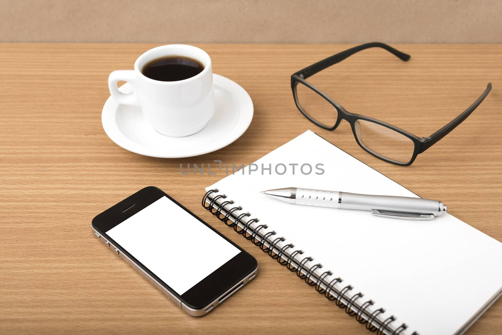 coffee,phone,notepad and eyeglasses on wood table background