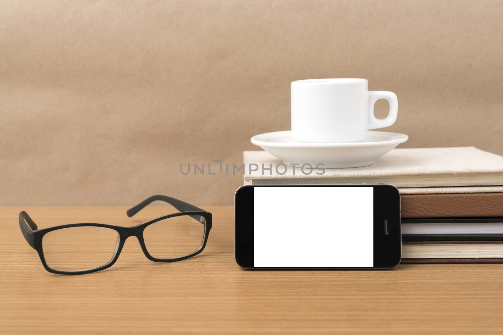 coffee,phone,stack of book and eyeglasses on wood table background