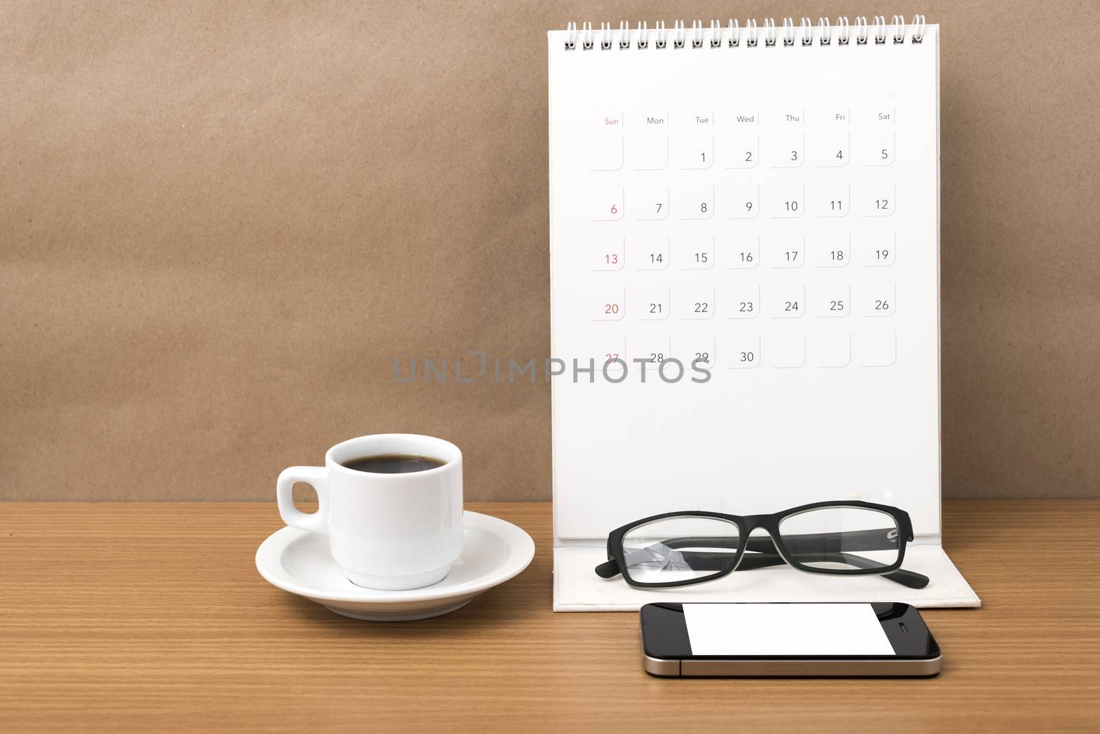 coffee,phone,eyeglasses and calendar on wood table background