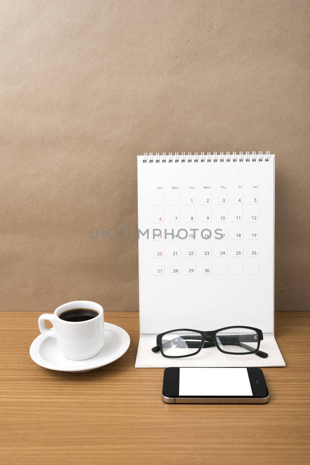 coffee,phone,eyeglasses and calendar on wood table background