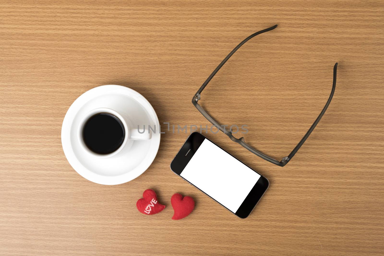 coffee,phone,eyeglasses and heart on wood table background