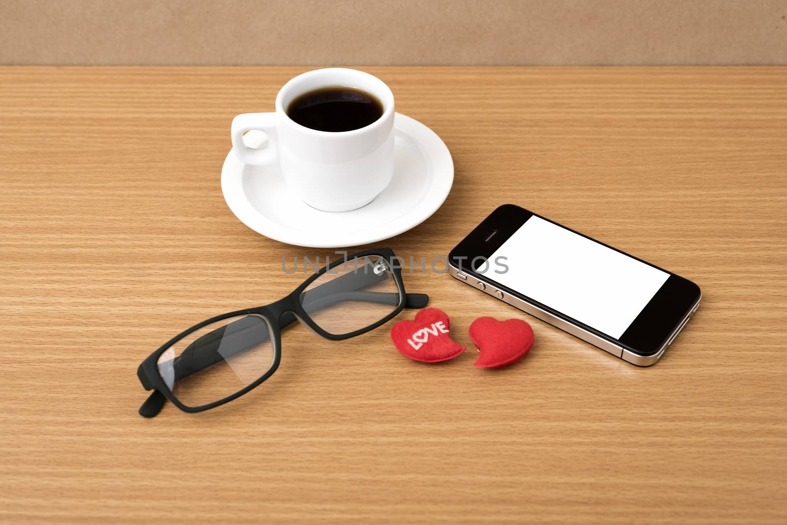 coffee,phone,eyeglasses and heart on wood table background