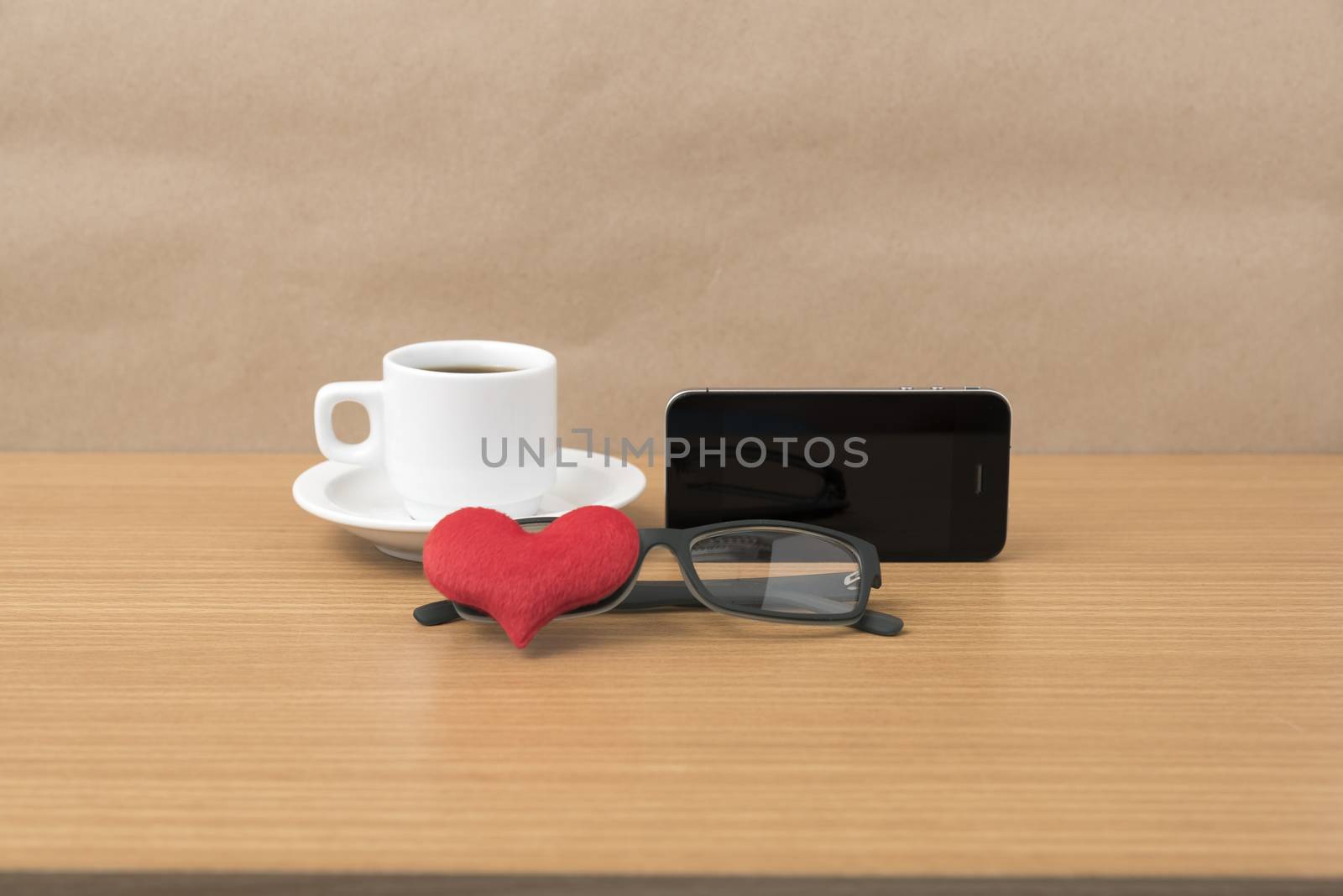 coffee,phone,eyeglasses and heart on wood table background