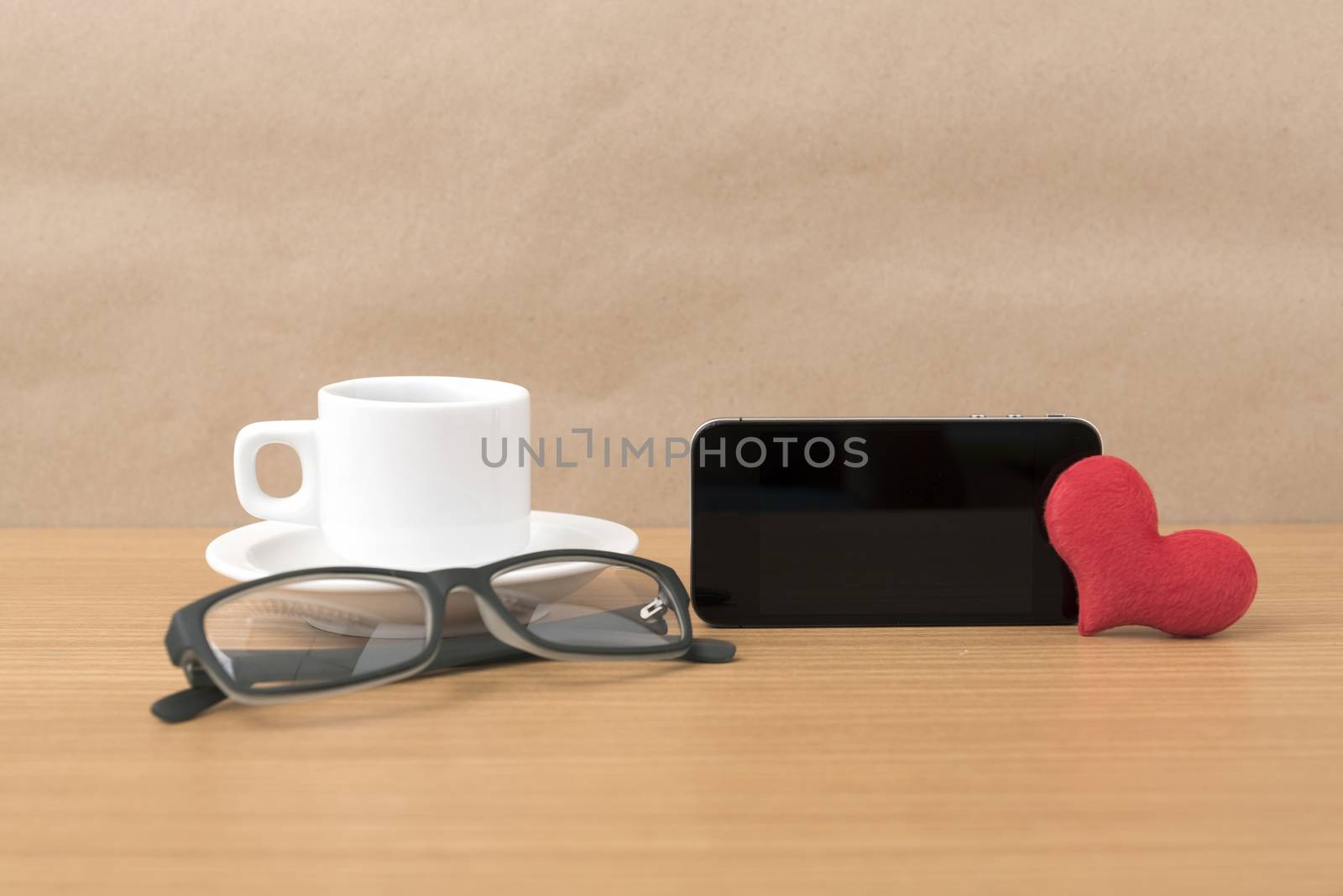 coffee,phone,eyeglasses and heart on wood table background