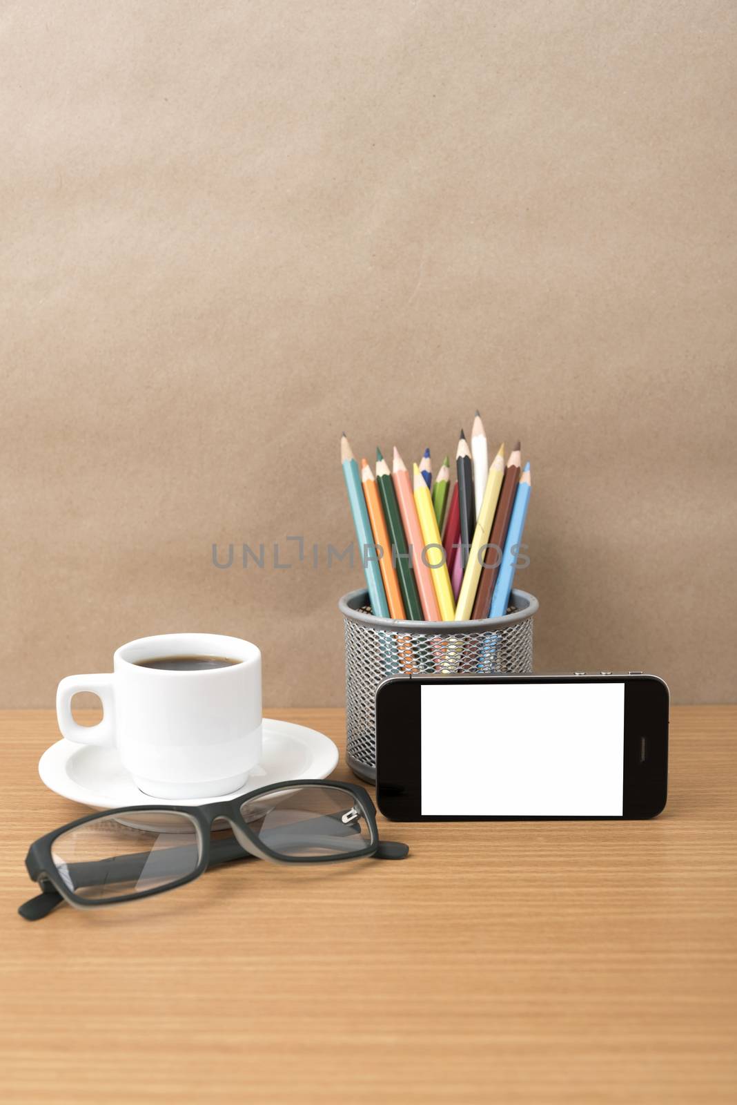 coffee,phone,eyeglasses and pencil on wood table background