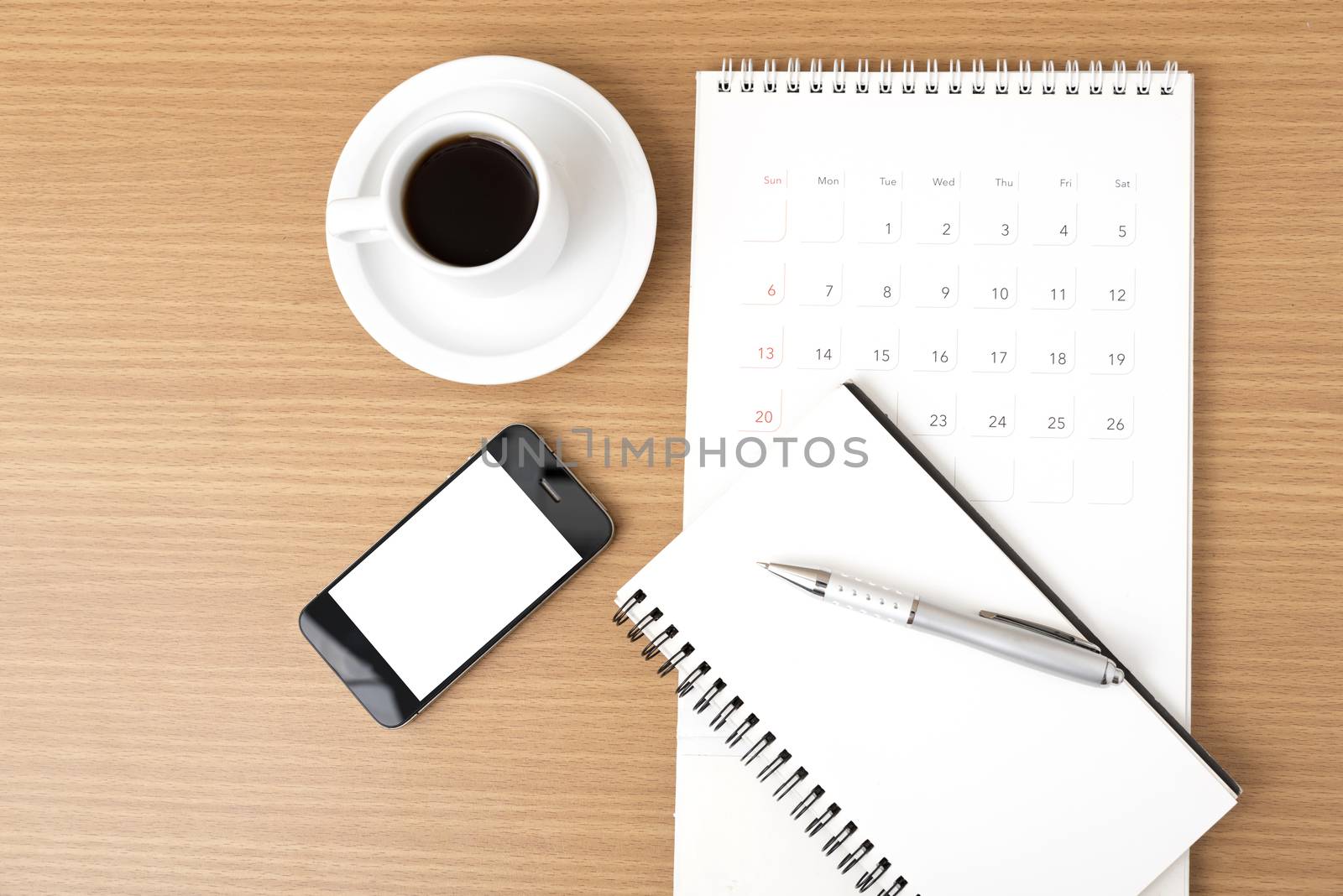 coffee,phone,notepad and calendar on wood table background