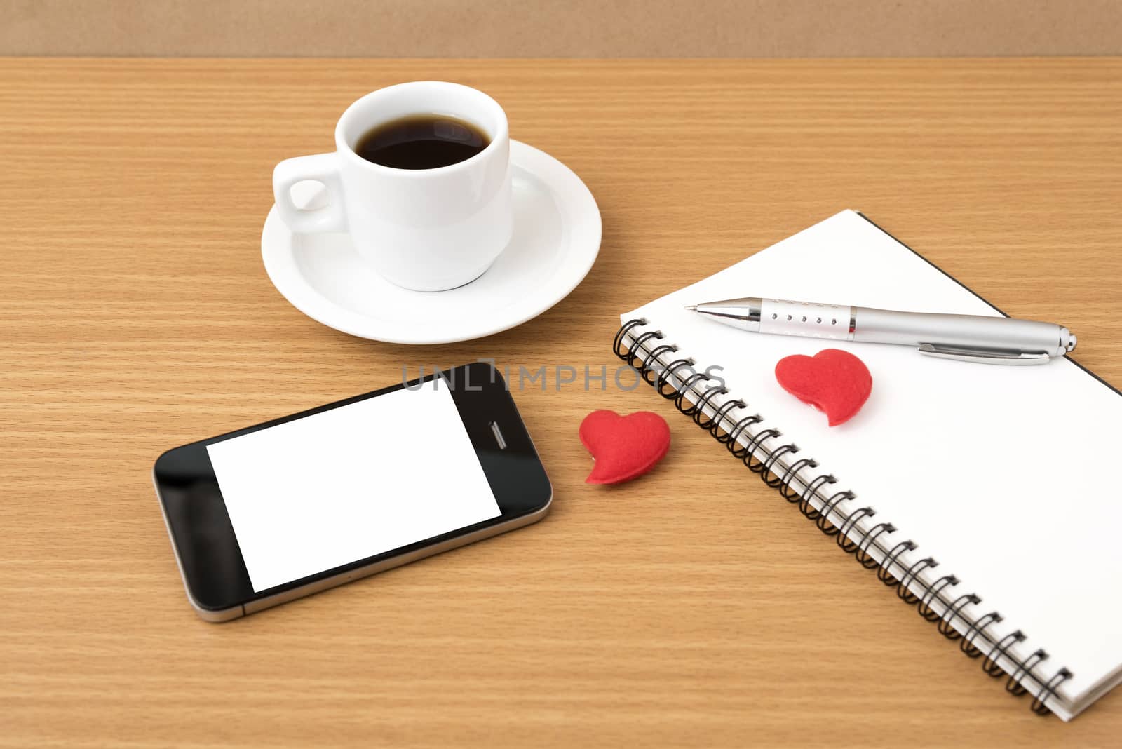 coffee,phone,notepad and heart on wood table background