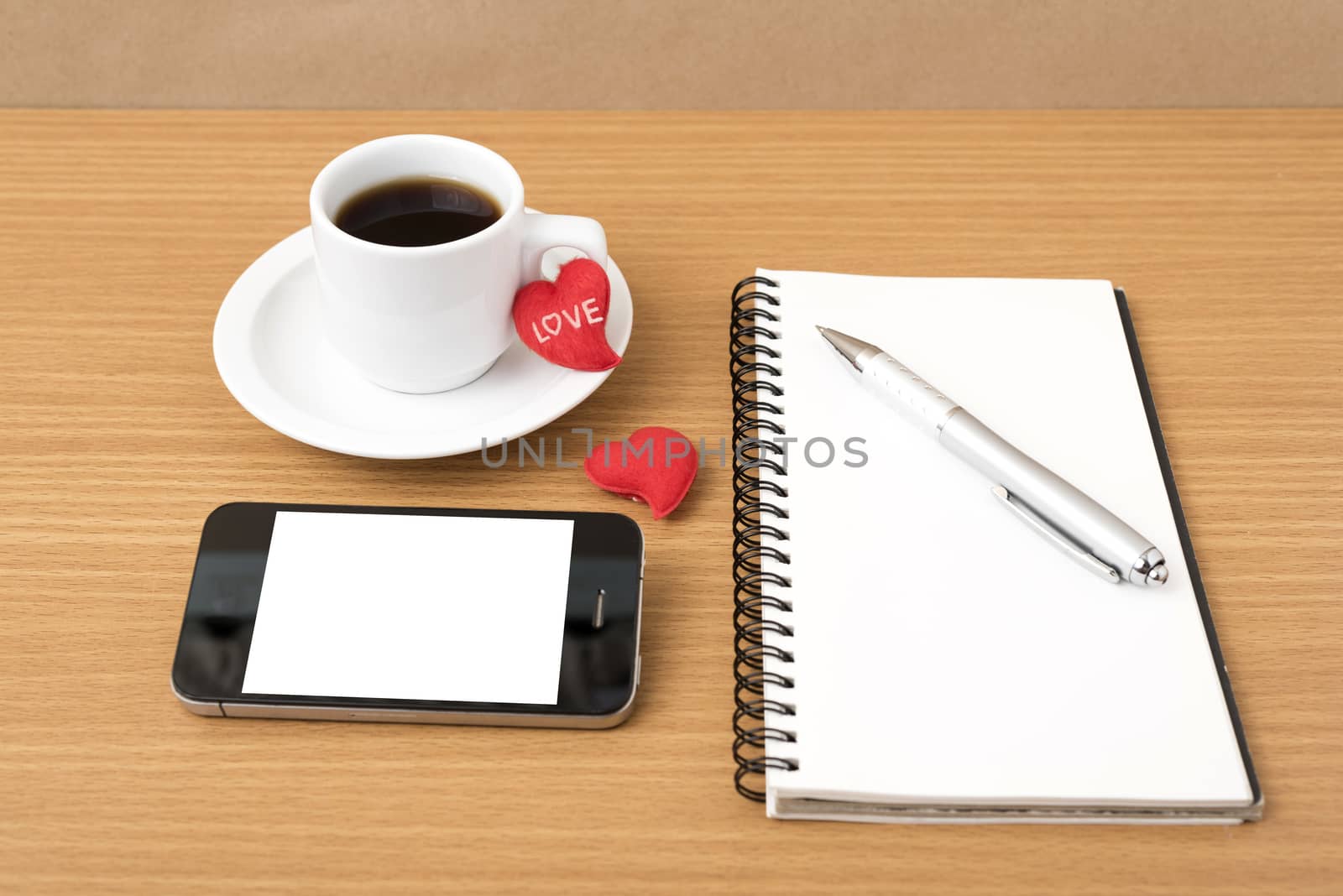 coffee,phone,notepad and heart on wood table background