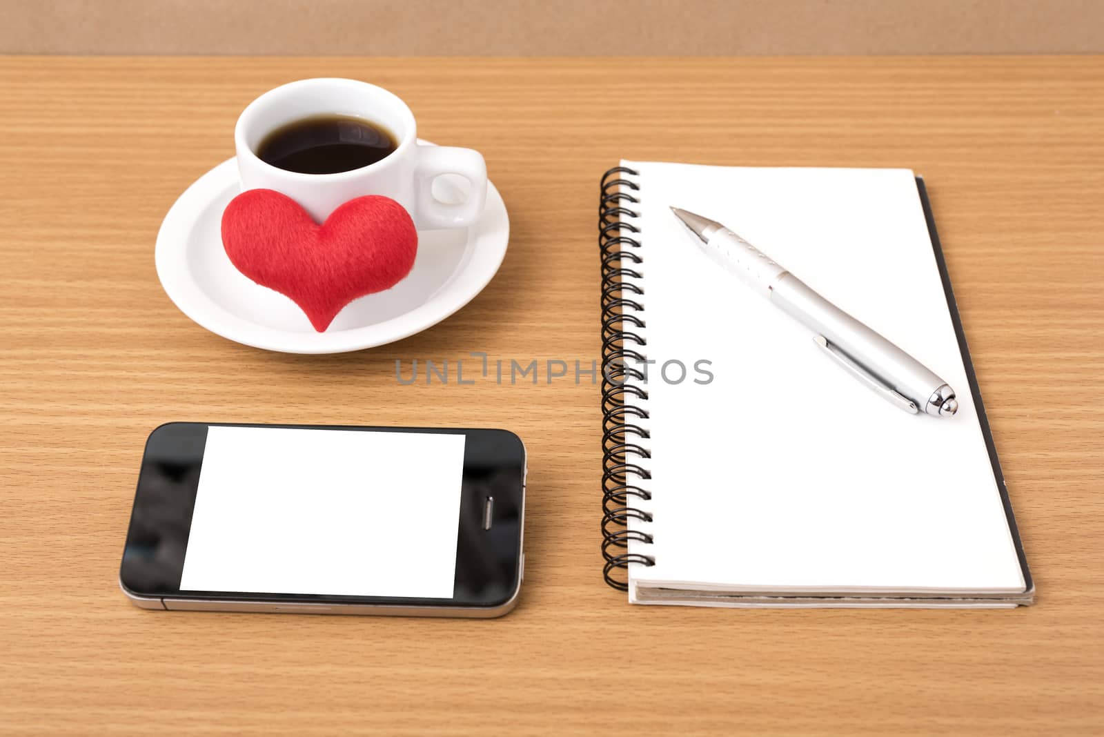coffee,phone,notepad and heart on wood table background