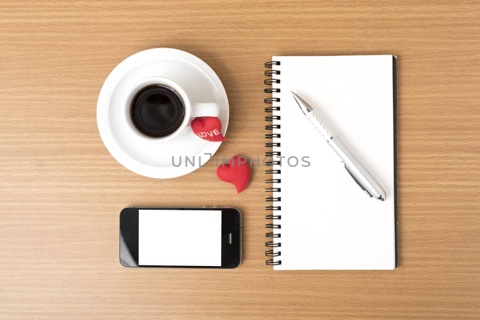 coffee,phone,notepad and heart on wood table background