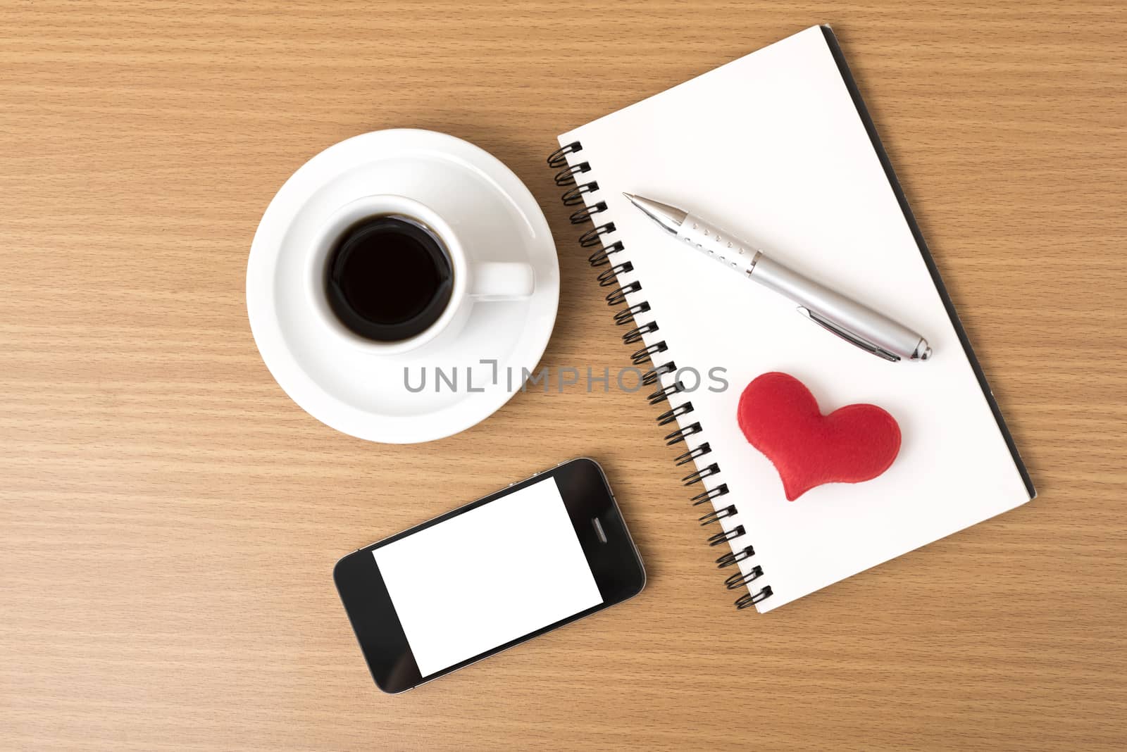 coffee,phone,notepad and heart on wood table background