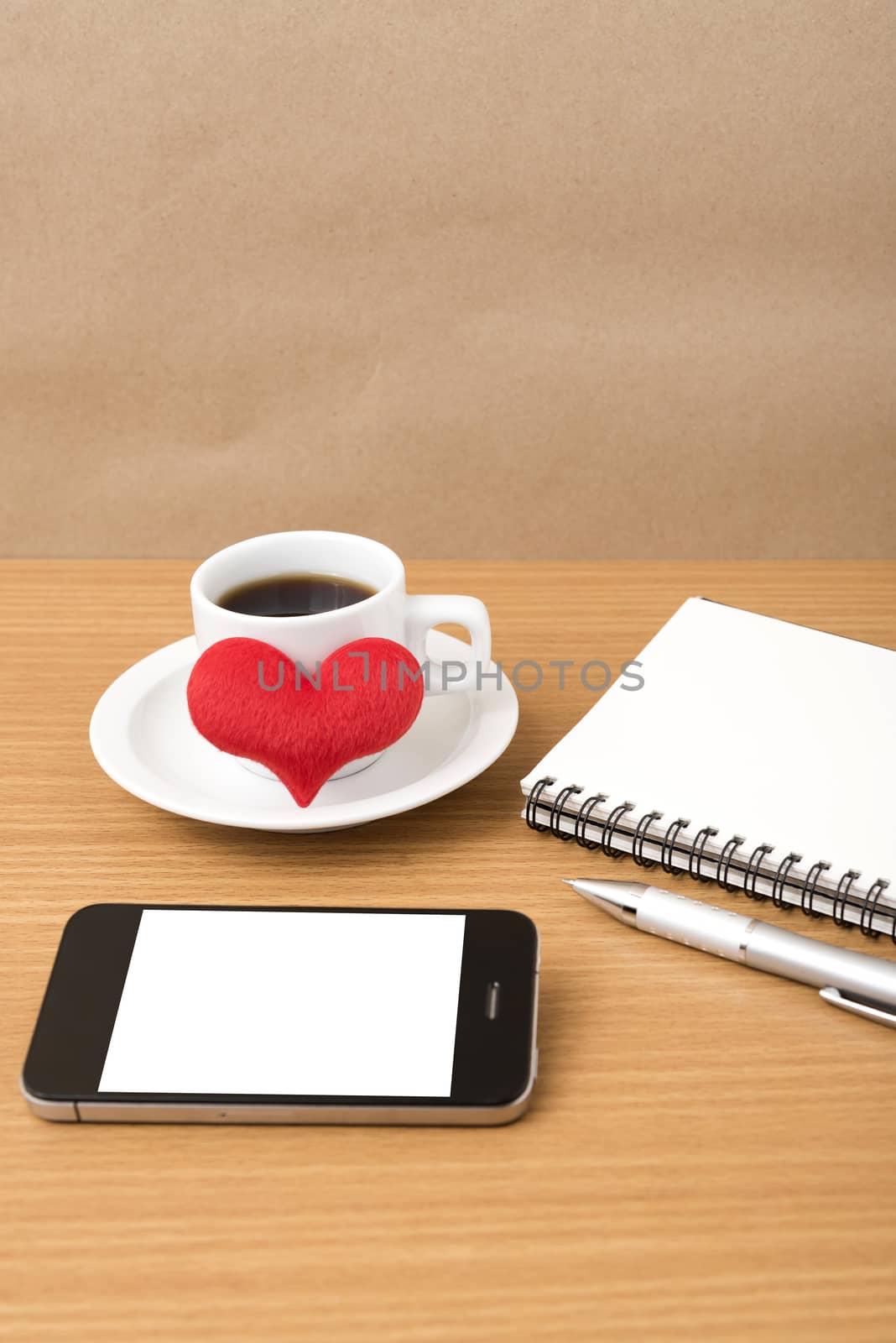 coffee,phone,notepad and heart on wood table background