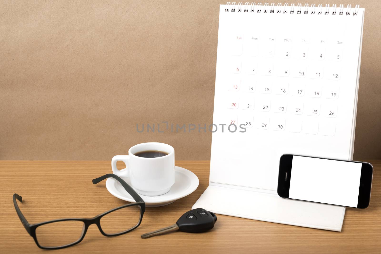 coffee,phone,car key,eyeglasses and calendar on wood table background