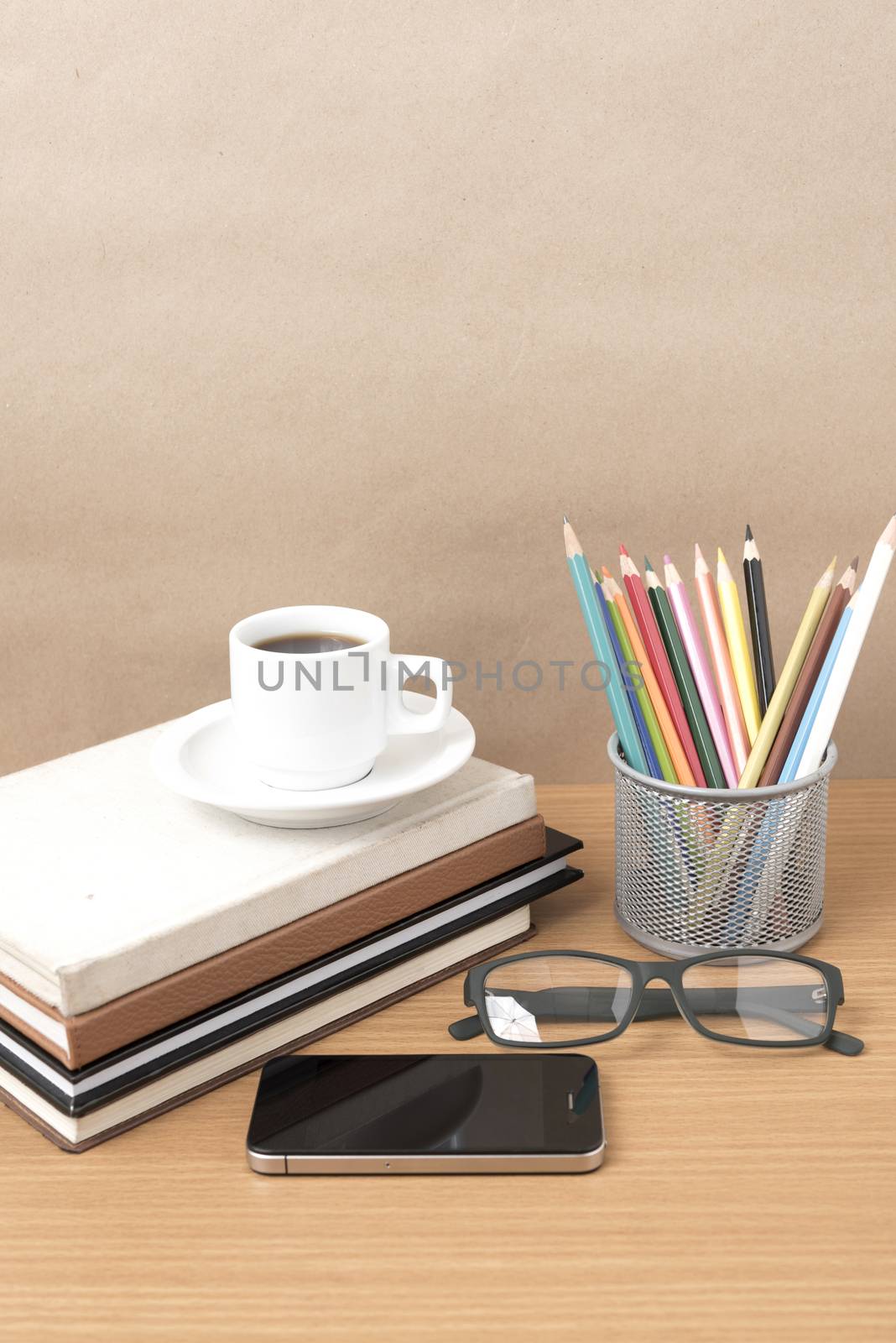 coffee,phone,eyeglasses,stack of book and color pencil on wood table background