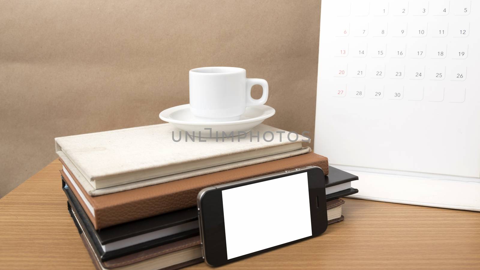 coffee,phone,stack of book and calendar on wood table background