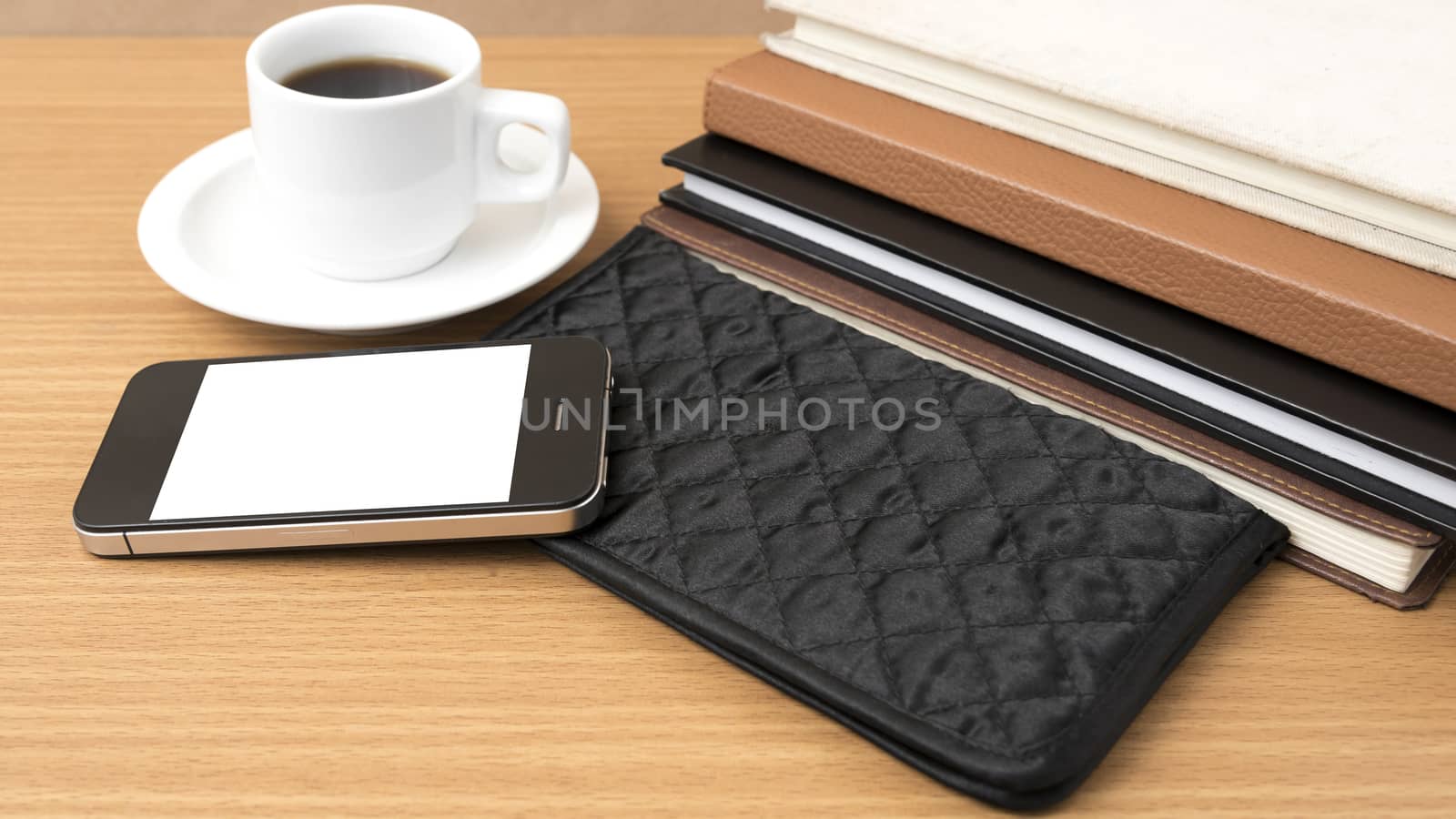 coffee,phone,stack of book and wallet on wood table background