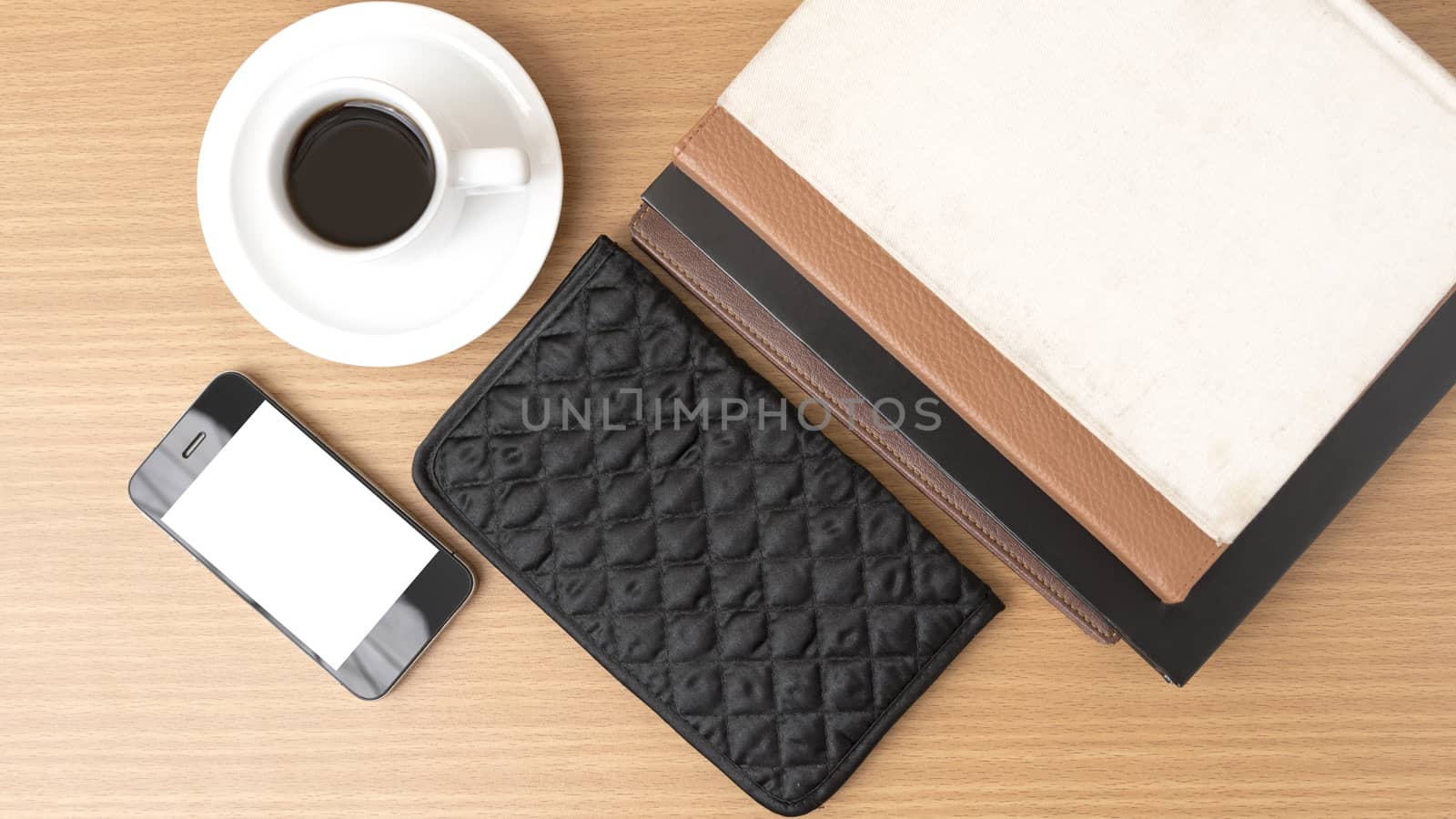 coffee,phone,stack of book and wallet on wood table background