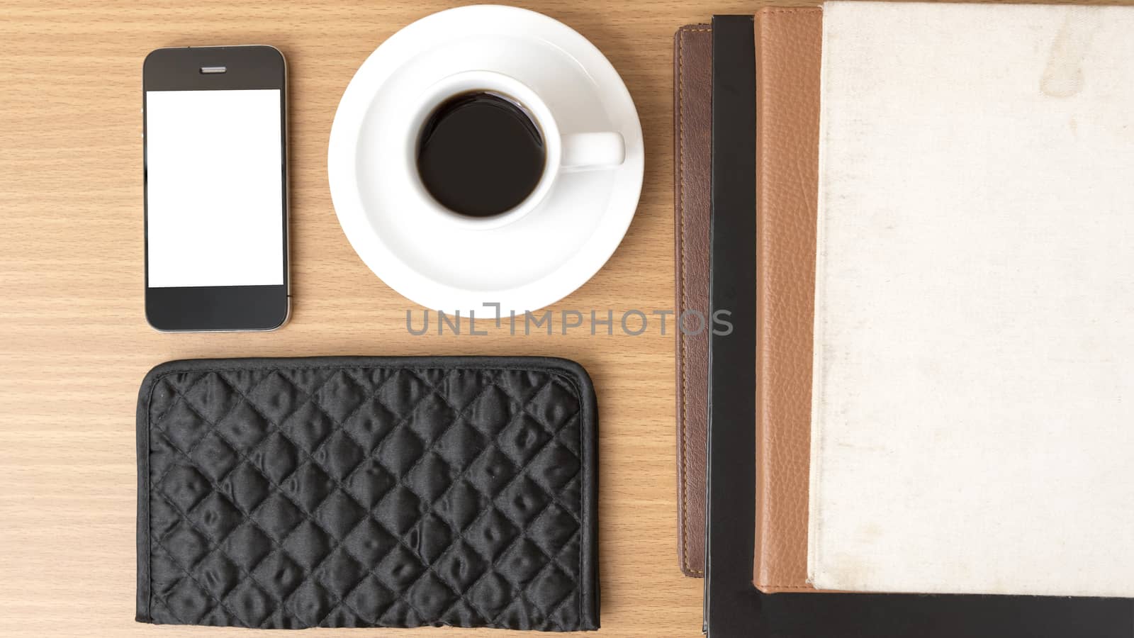 coffee,phone,stack of book and wallet on wood table background