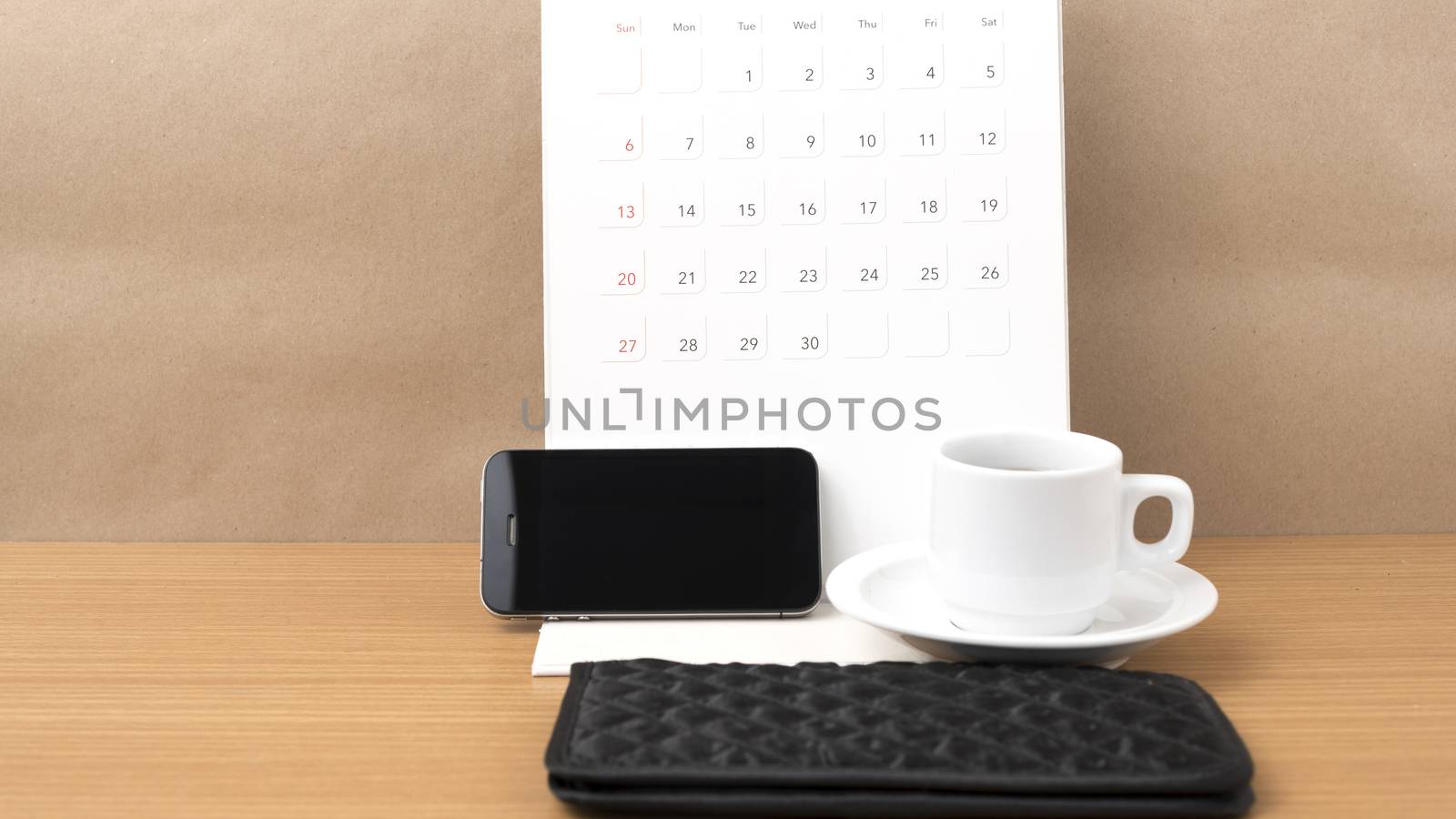 coffee,phone,wallet and canlendar on wood table background