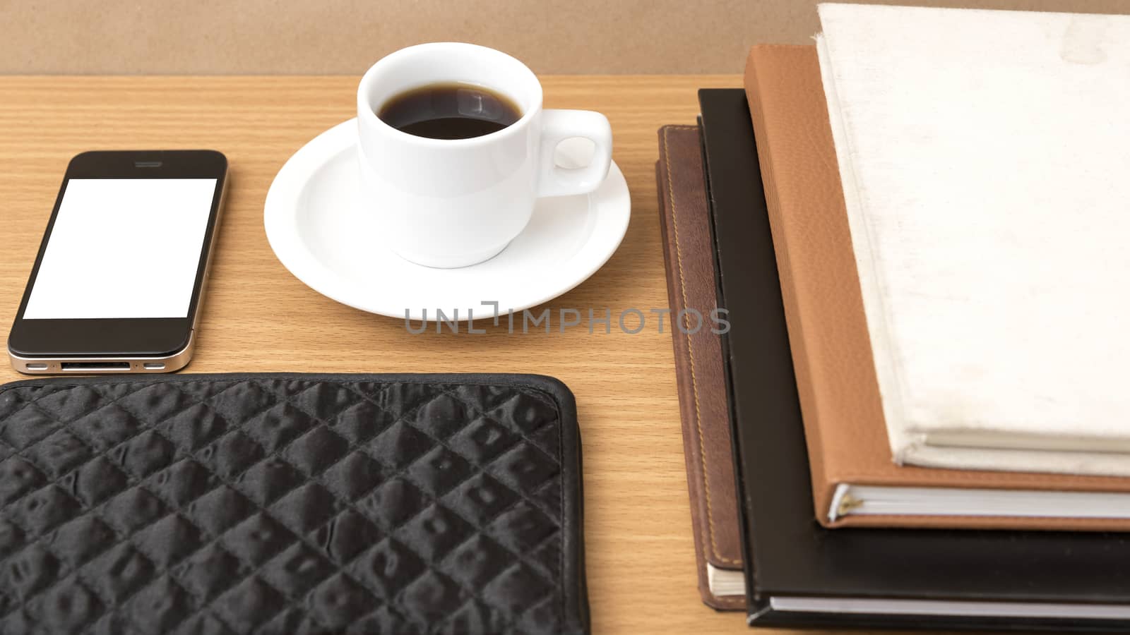 coffee,phone,stack of book and wallet on wood table background