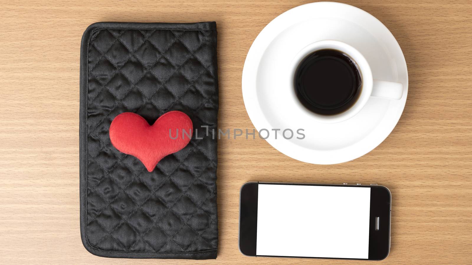 coffee,phone,wallet and heart on wood table background