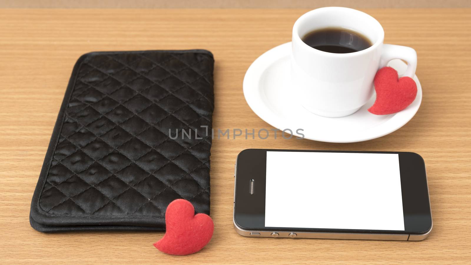 coffee,phone,wallet and heart on wood table background